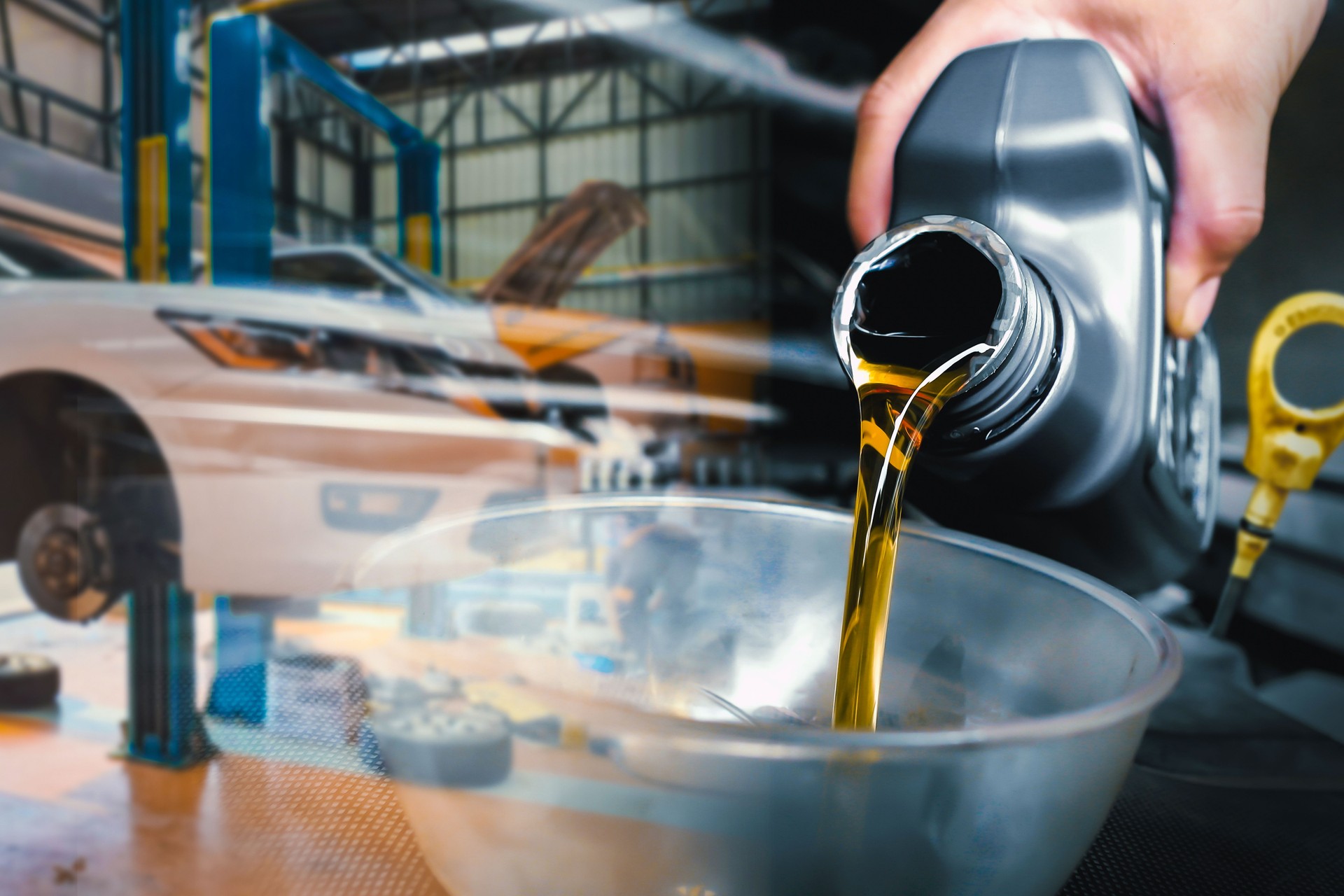 Oil change process in automotive service garage , Double exposure , The mechanic poured engine oil into a funnel on the engine oil fill port